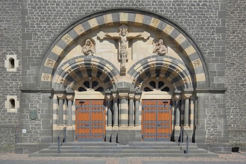 Portal with crucifix of the Herz-Jesu-Kirche built in 1912, church door with fittings, church