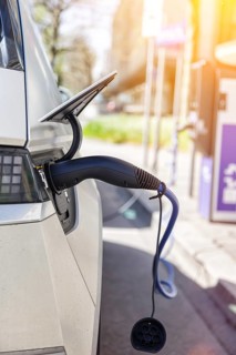 Charging the battery of an electric car with electricity E-car at an electric petrol station petrol