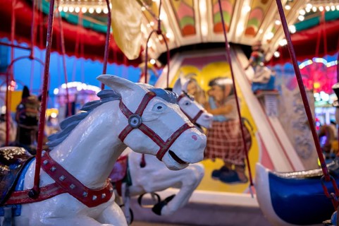 Horses on children's carousel, rides, neon lights, Cannstatter Wasen, funfair, spring festival,