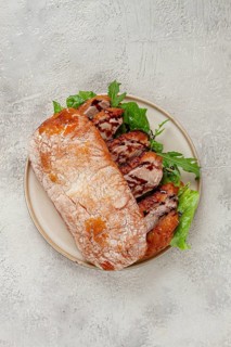 Sandwich with duck breast and arugula, balsamic sauce, on a light plate, breakfast, homemade, no