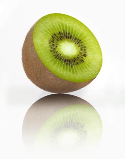 Half a kiwi, kiwi fruit, Chinese gooseberry (Actinidia deliciosa) against a white background,