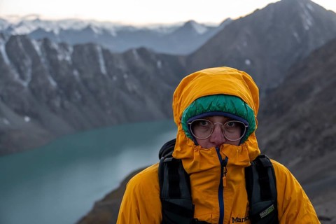 Mountaineer at Ala Köl mountain lake, in the Tien Shan Mountains, near Altyn Arashan, Kyrgyzstan