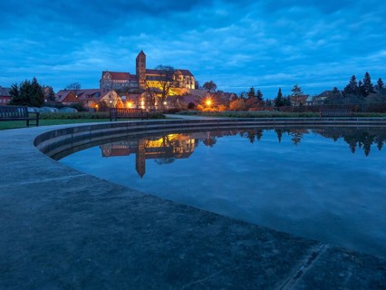 Castle hill with collegiate church St. Servatius with reflection in water basin in the evening,
