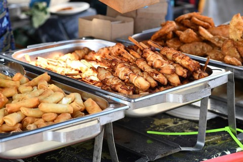 Fried Thai street food like spring rolls and chicken skewers