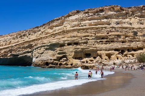 Matala beach with a view of the rock caves, south coast, Crete, Greece