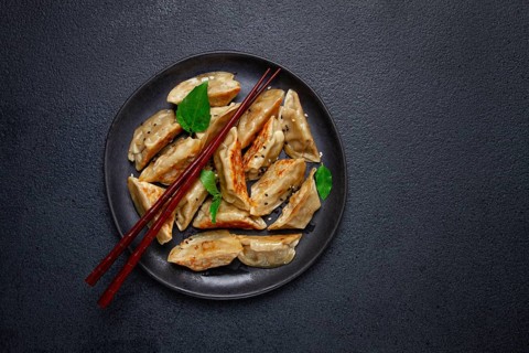 Japanese fried gyoza dumplings, with pork, sesame seeds, green onions