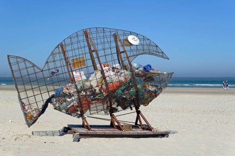 Wire sculpture as a rubbish bin on the sandy beach of Norderney, North Sea, East Frisian Islands,