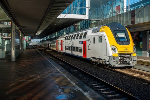 Passenger train at empty platform in the Gent-Sint-Pieters railway station in Ghent during public