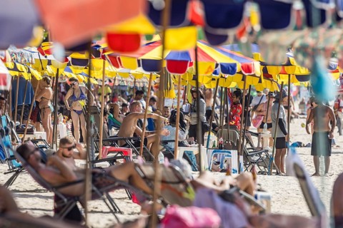 Overtourism in Thailand. Mass tourism on the sandy beach of Patong, the deckchairs are packed