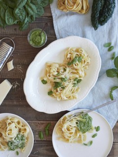 Green Tagliatelle pasta with spinach and kale pesto beside parmesan cheese. Traditional Italian