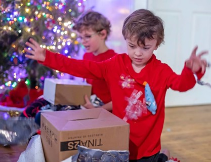 Denver, Colorado - Hendrix Hjermstad, 6, (right) and his brother Adam Hjermstad Jr., 10, open