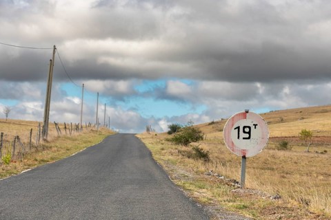 Desolate road in the countryside on a sunny summer day. Cevennes, France