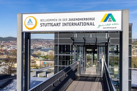 Youth hostel with DJH logo. Entrance area with a view of the state capital Stuttgart,