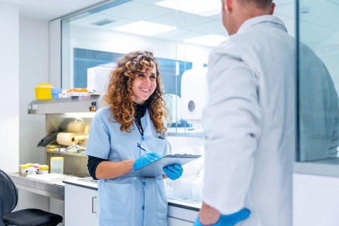 Scientists writing data working in a research laboratory in an hospital