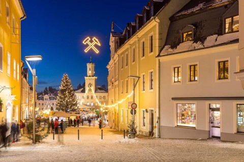 Christmas market with town hall and Christmas tree at the blue hour in Schneeberg, Erzgebirge,