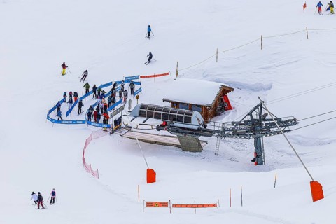Skiers at the valley station of the chairlift to the summit of Corne de Sorebois, Val d'Anniviers,