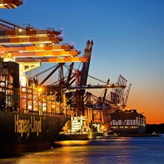 Container ships at the Eurogate container terminal in the evening with an atmospheric sunset,