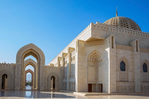 Arched gates and large hall with dome of the Sultan Qaboos Mosque, Muscat, Arabian Peninsula,