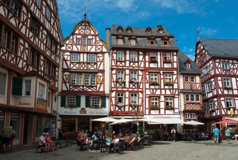 Lively square in the old town centre with half-timbered houses and cafés in sunny weather, market