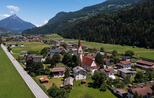Drone shot, view of village with parish church, Schönwies, Oberinntal, Tyrol, Austria