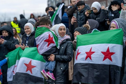 Syrian woman celebrate the end of the Assad regime after the change of power in Syria at a rally on