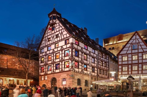 Historic Pilkatushaus with an Advent calendar on 18 December 2024 at dusk, behind the Imperial
