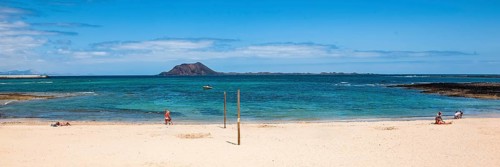 Panoramic photo of Corralejo beach in the background uninhabited island Islote de Lobos in the East