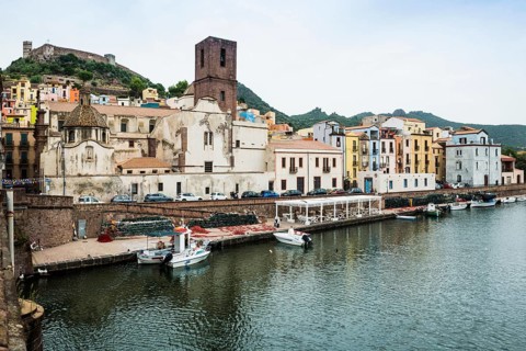 Colourful houses and fishing boats on the river Terno, Bosa, district of Oristano, Sardinia, Italy
