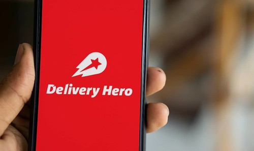 Delivery Hero logo is displayed on smartphone