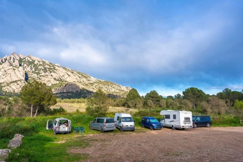 Camper vans enjoying the breathtaking view of the montserrat massif in catalonia, a popular