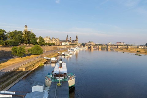 Silhouette of the Old Town with reflection in the Elbe in the morning, steamboats on the