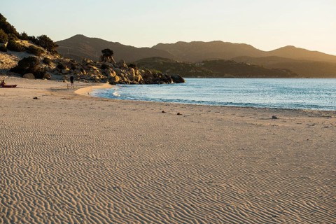 Lonely beach and rocks, sunrise, Spiaggia di Porto Giunco, Villasimius, south coast, Sardinia,