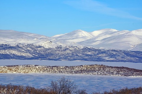 Snow-covered mountains and a frozen lake in a cold winter landscape, Abisko, Abisko National Park,