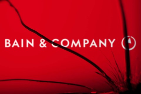 Bain & Company logo is visible on the broken glass. Bain & Company is an American management