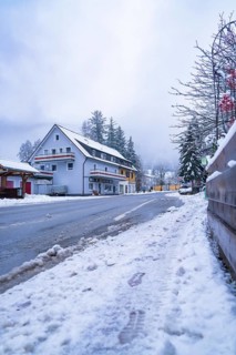 Snow-covered road with building in the background, Enzklösterle, Calw district, Black Forest,