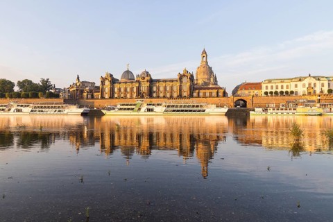 Silhouette of the Old Town with reflection in the Elbe in the morning, steamboats on the