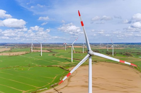 Aerial view over wind turbines at wind park, windfarm in Schleswig-Holstein, Germany