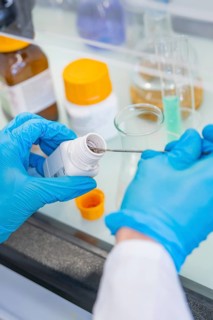 A spoon is inserted into a small bottle of chemicals, Nagold Youth Research Centre, Black Forest