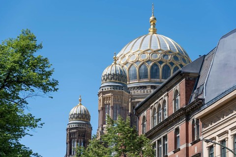 New synagogue in Berlin with golden domes and classical architecture against a blue sky, Berlin,