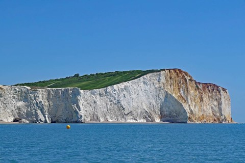 Majestic chalk cliffs above the blue sea under a clear sky, English Channel, Eastbourne, Sussex,