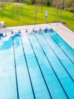 Long swimming lanes in the outdoor pool surrounded by greenery, Calw Stammheim outdoor pool, Calw,