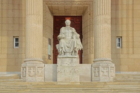 Johann Wolfgang von Goethe sitting on a throne, stone sculpture, monument, ruler, exalted, victor,