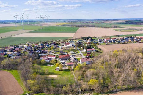 Aerial view of Grubnitz, in the background the village of Mautitz and wind turbines, Stauchitz,