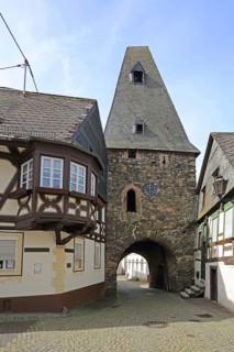 Historic clock tower and half-timbered house with oriel, landmark, town gate, town tower,
