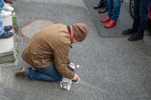 Pupil polishes and cleans a stumbling stone to commemorate the Night of Broken Glass on 9 November