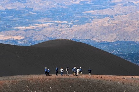 Hikers in the crater landscape of the volcano Etna, summit region, province of Catania, Sicily,