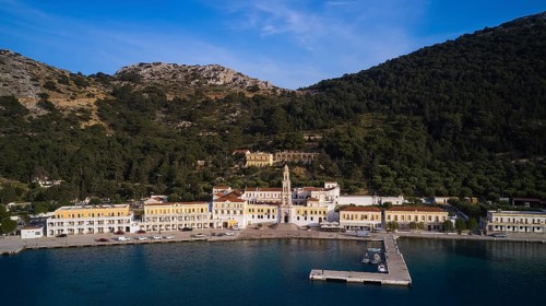 Drone shot, coastline with harbour and historic buildings surrounded by mountains, Holy Week, Bay