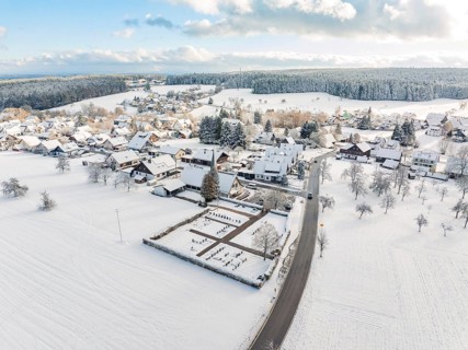 Snow-covered village with church and surrounding fields and forests, Oberreichenbach, Black Forest,