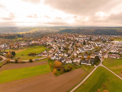 Far-reaching view over a village and fields in an autumnal atmosphere, Tiefenbronn, Germany