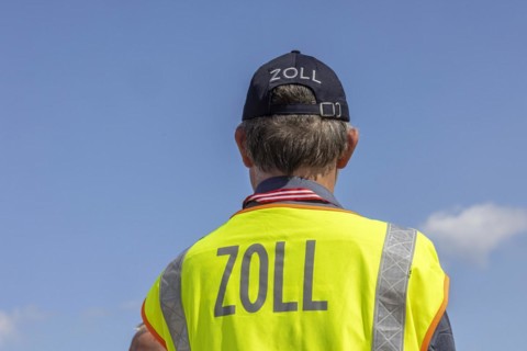 Customs officers wearing high-visibility waistcoats, Schönefeld Airport apron, Brandenburg, Germany